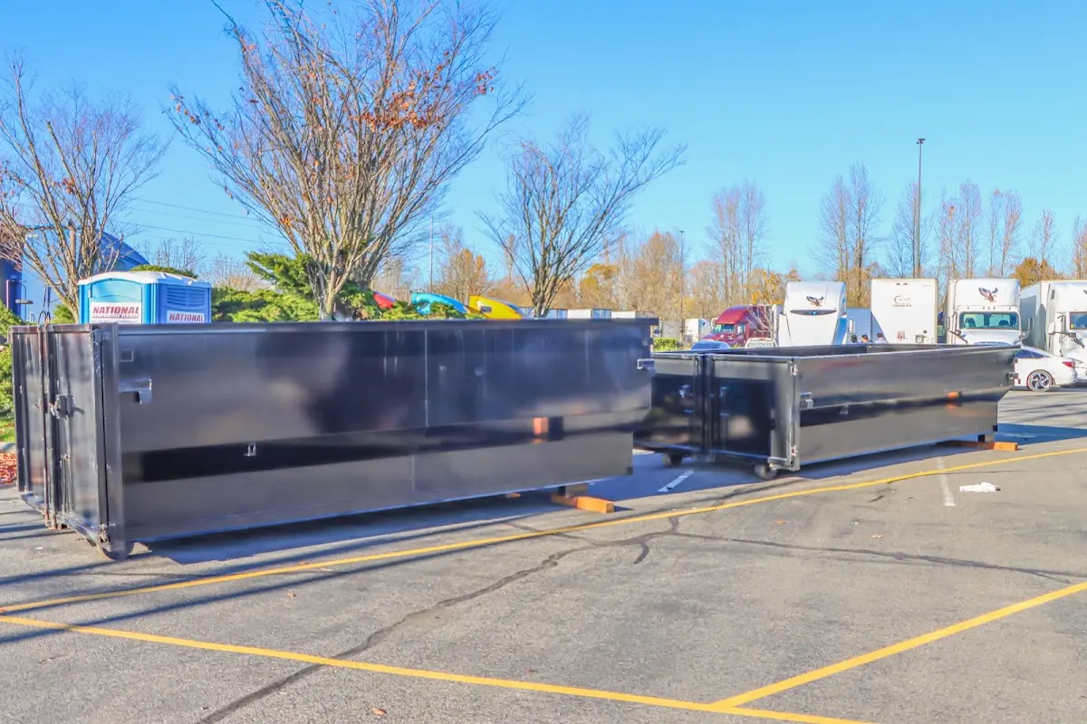 Professional dumpster rental service with roll-off container on residential driveway in Blair